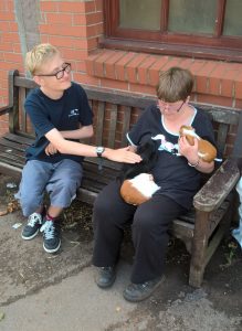 Lewis pets the guinea pigs at Elm Tree Farm