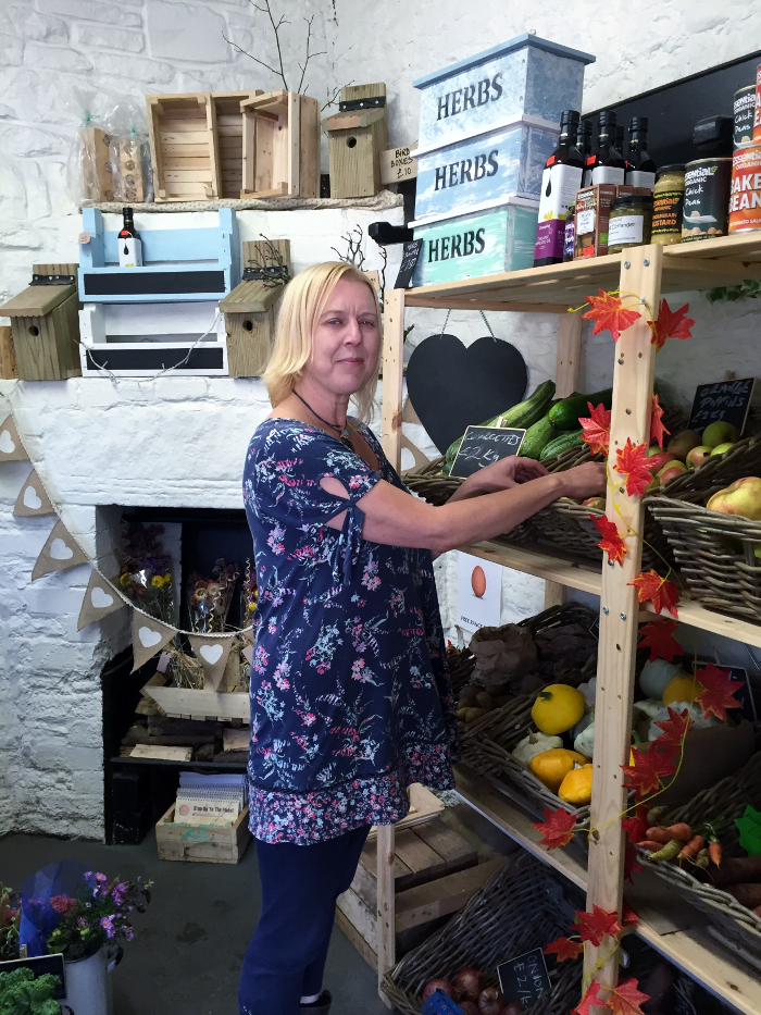 Anne White stocks the shelves at Elm Tree Farm shop